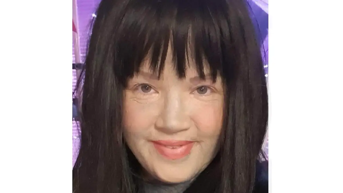 Melissa Sloan mit Make-up, das ihre Tattoos abdeckt, und mit Perücke